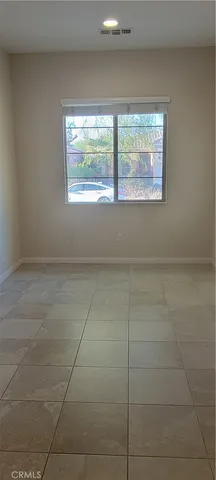 a view of a small space with wooden floor and a window