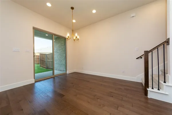 an empty room with wooden floor and door