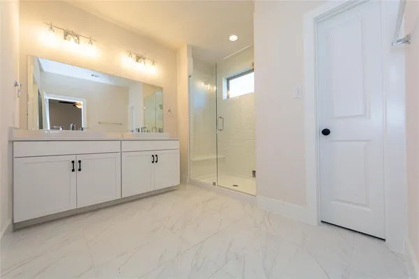 a bathroom with a double vanity sink and mirror