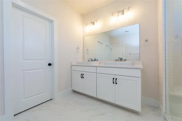 a bathroom with a double vanity sink and mirror