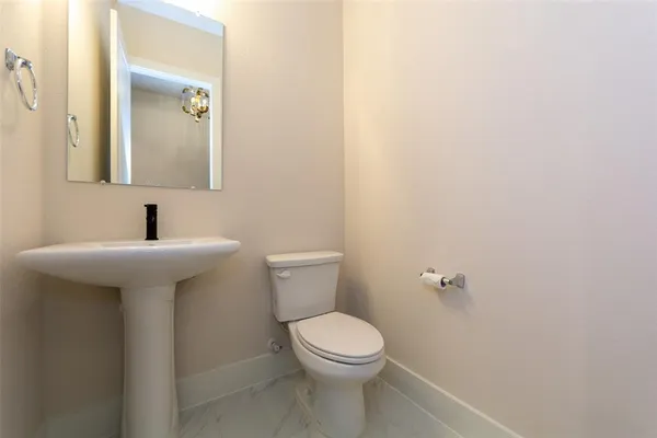 a bathroom with a sink a toilet and mirror