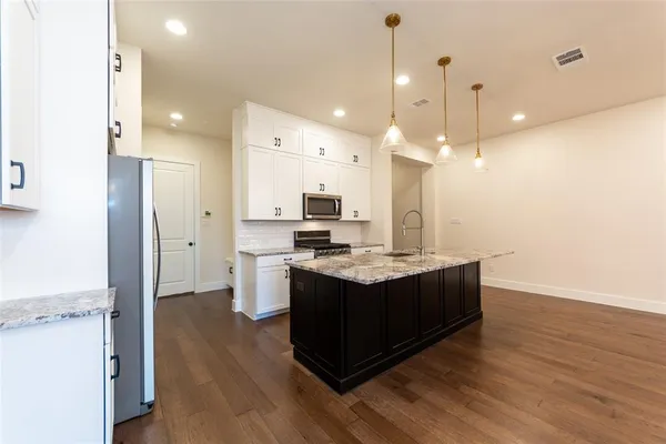 a kitchen with a sink and a refrigerator