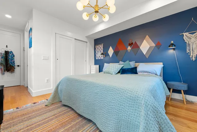 a bedroom with a bed and a chandelier