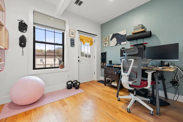 a bedroom with bed and gym equipment