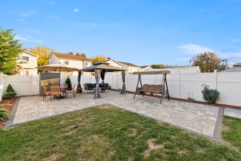 a view of a patio with chairs and plants