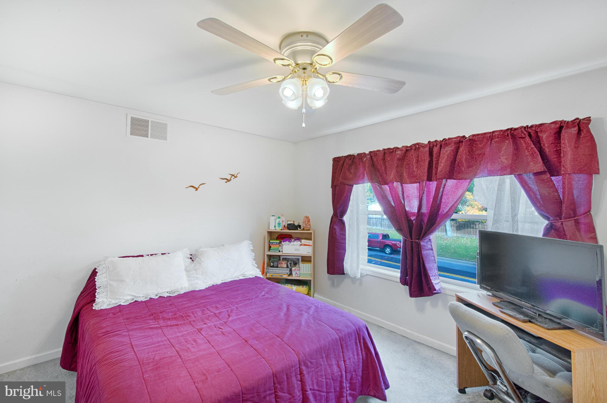 7205 Gunpowder Road Middle River, MD 21220 - Photo 14 of 25 a bedroom with a bed and a chandelier