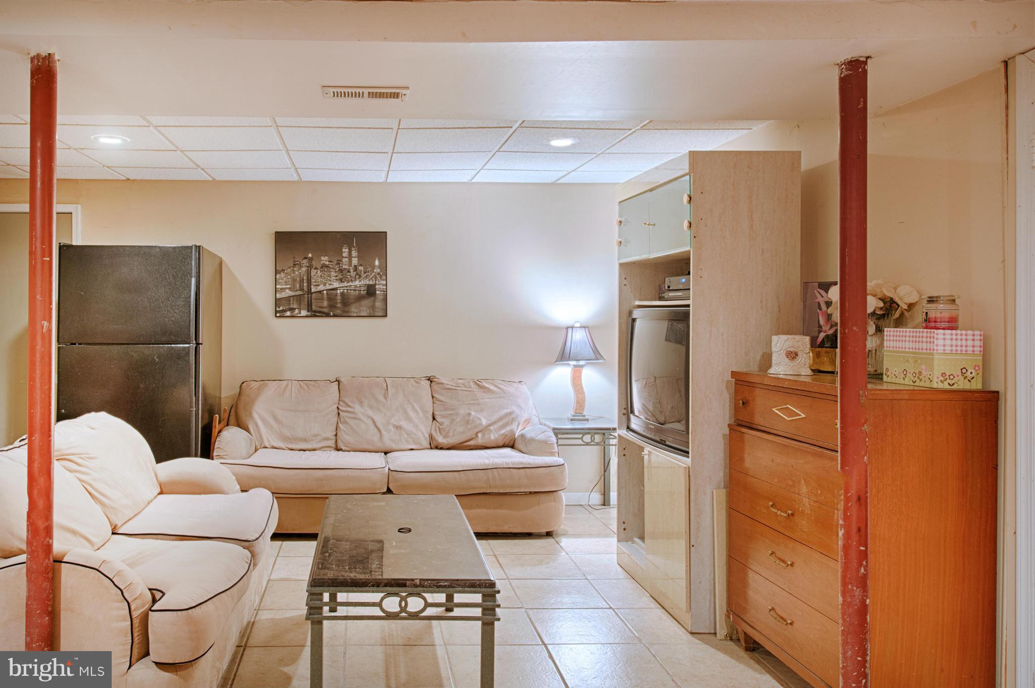 7205 Gunpowder Road Middle River, MD 21220 - Photo 20 of 25 a living room with furniture and a refrigerator