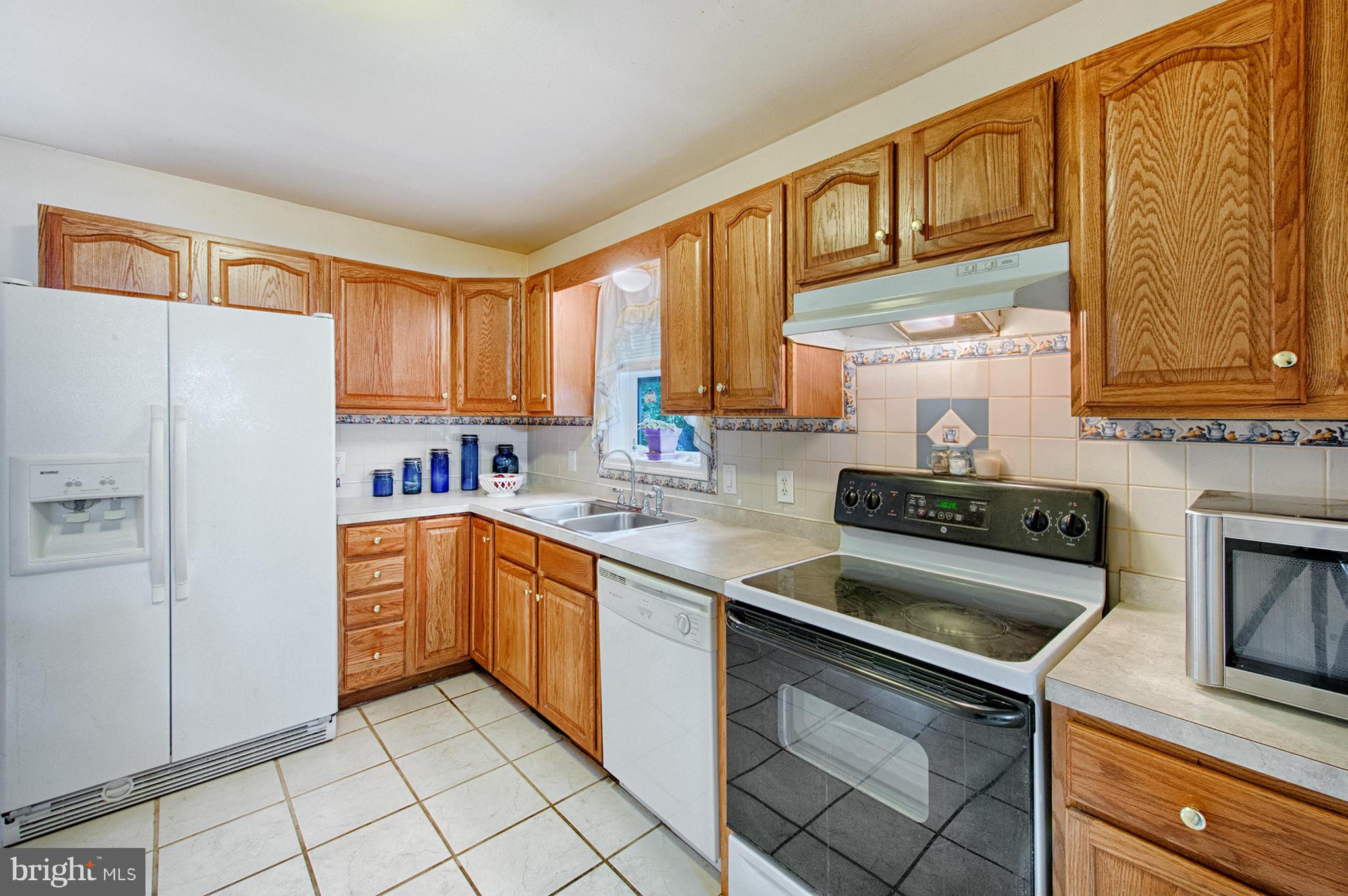 7205 Gunpowder Road Middle River, MD 21220 - Photo 8 of 25 a kitchen with stainless steel appliances granite countertop a stove a sink and a refrigerator