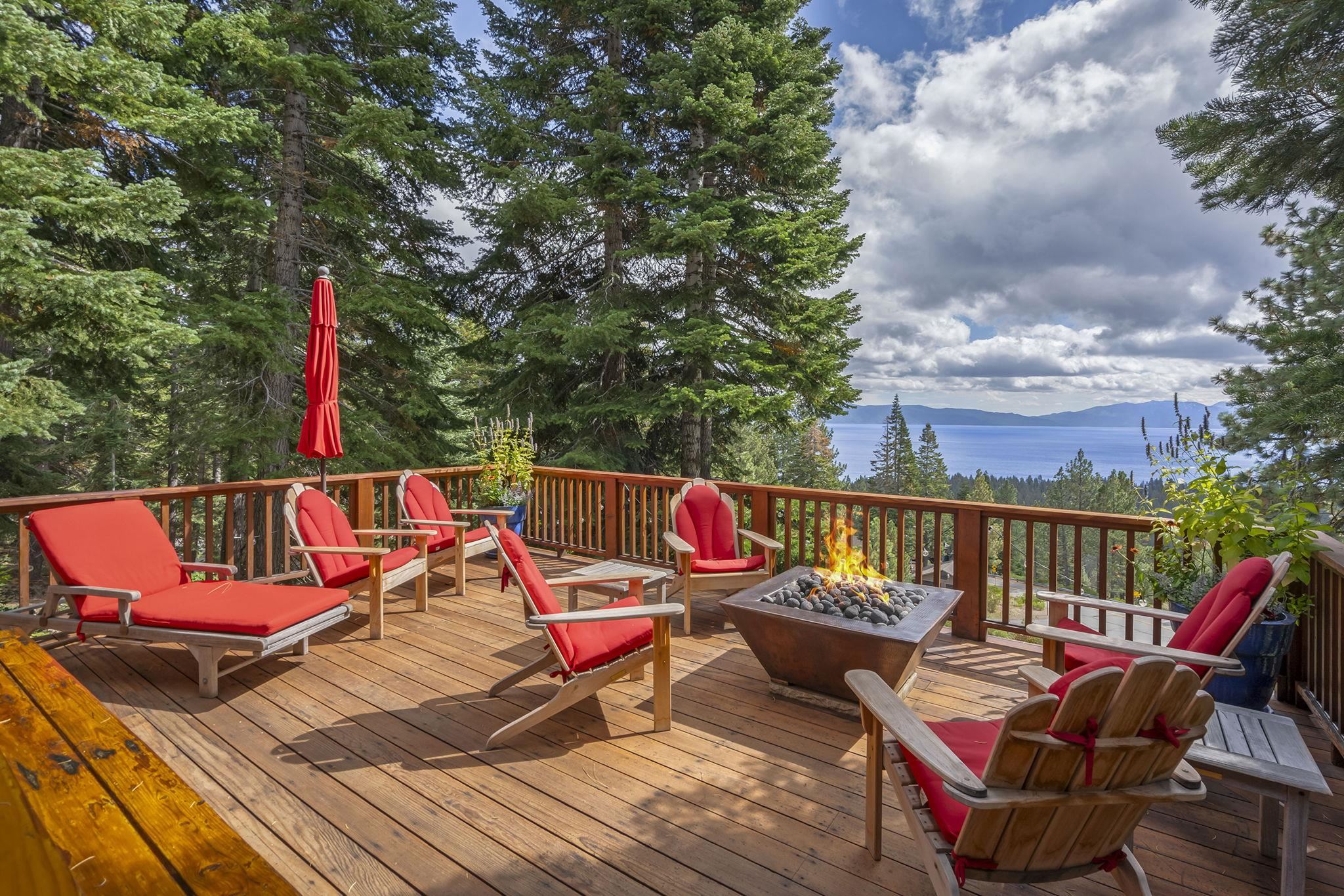 an outdoor sitting area with furniture and wooden floor