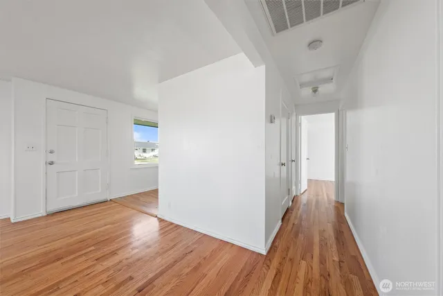 a view of a hallway with wooden floor