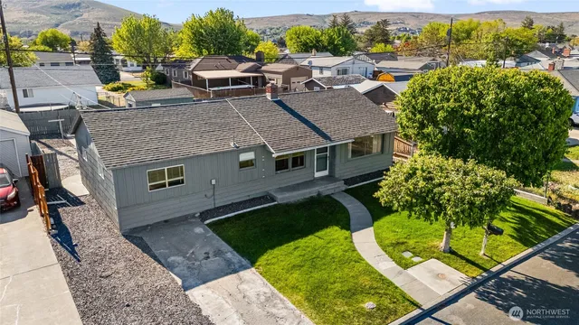 an aerial view of a house with a yard table and chairs