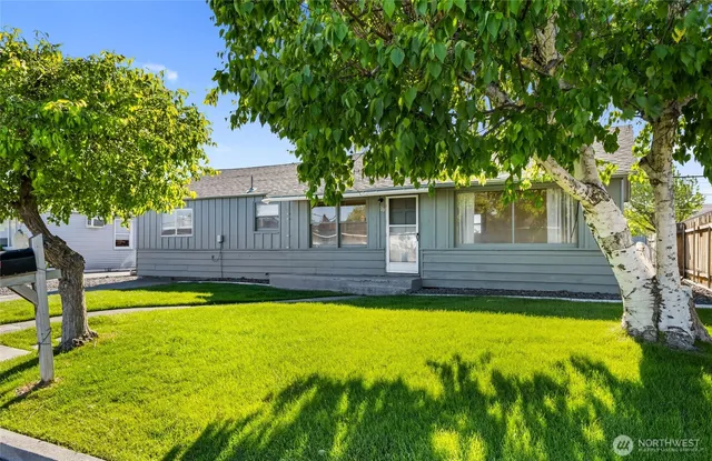 a view of a house with swimming pool and a yard