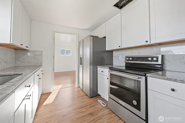 a kitchen with a stove microwave and a refrigerator