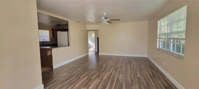 wooden floor in an empty room with a window
