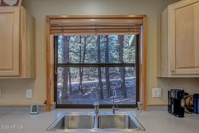 a view of a kitchen with a sink and cabinets