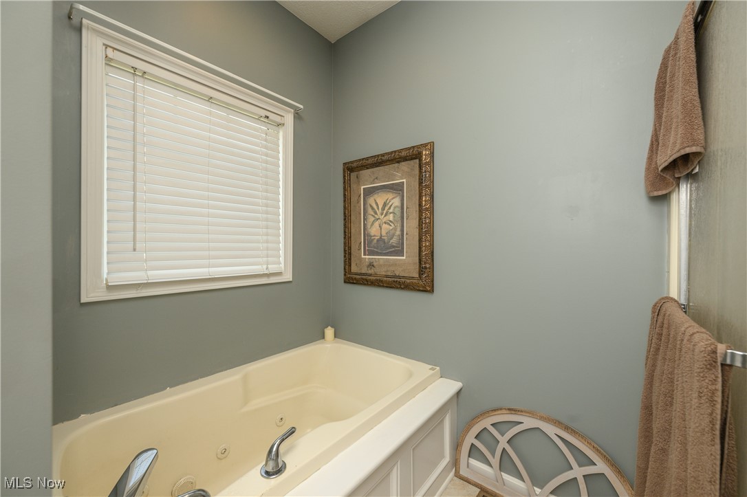 6986 Sweetwater Road Northeast Canton, OH 44721 - Photo 14 of 36 Master Bathroom featuring Jacuzzi Tub and walk-on shower