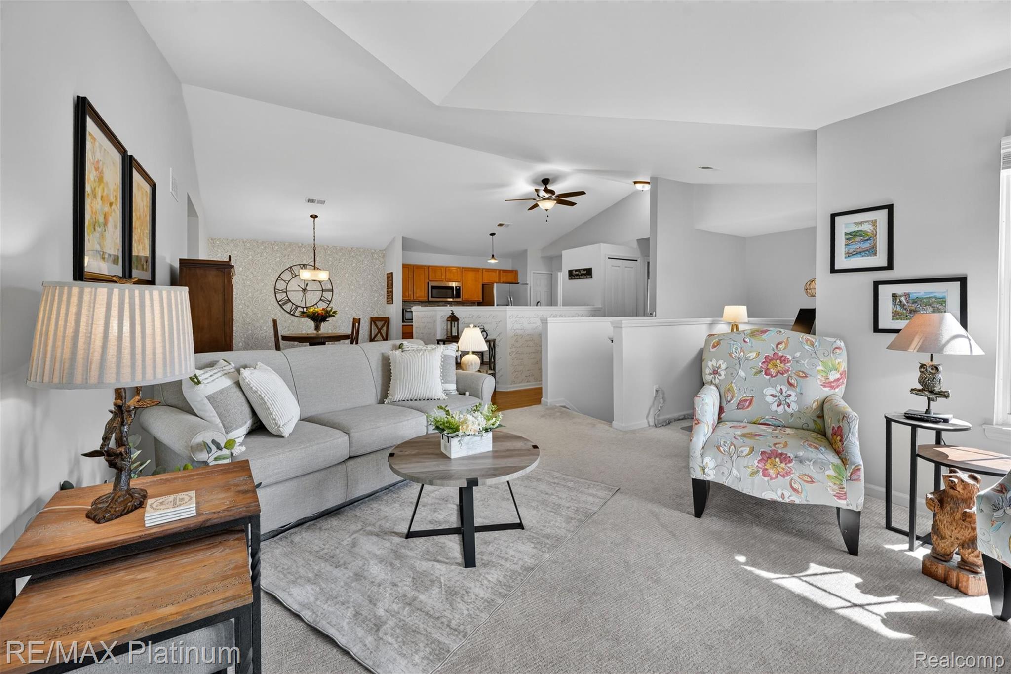 4191 Hampton Ridge Boulevard, Unit 41 Howell, MI 48843 - Photo 4 of 23 Living area featuring carpet, vaulted ceiling, ceiling fan, and wallpapered walls