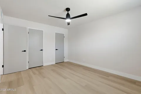 a view of empty room with ceiling fan