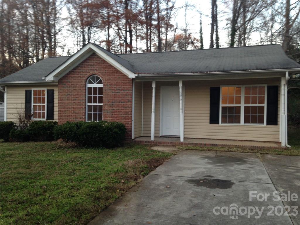 6019 Double Rein Road Charlotte, NC 28215 - Photo 1 of 21 a front view of a house with a yard