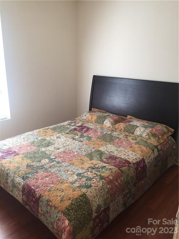 6019 Double Rein Road Charlotte, NC 28215 - Photo 11 of 21 a bedroom with a bed and a night stand