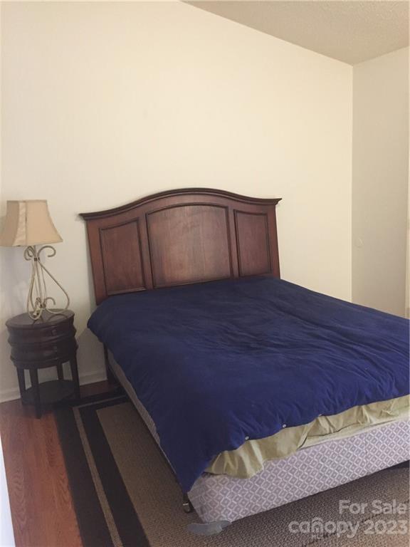 6019 Double Rein Road Charlotte, NC 28215 - Photo 13 of 21 a large bed sitting in a bedroom next to a lamp