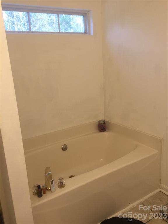 6019 Double Rein Road Charlotte, NC 28215 - Photo 16 of 21 a bathroom with a bathtub
