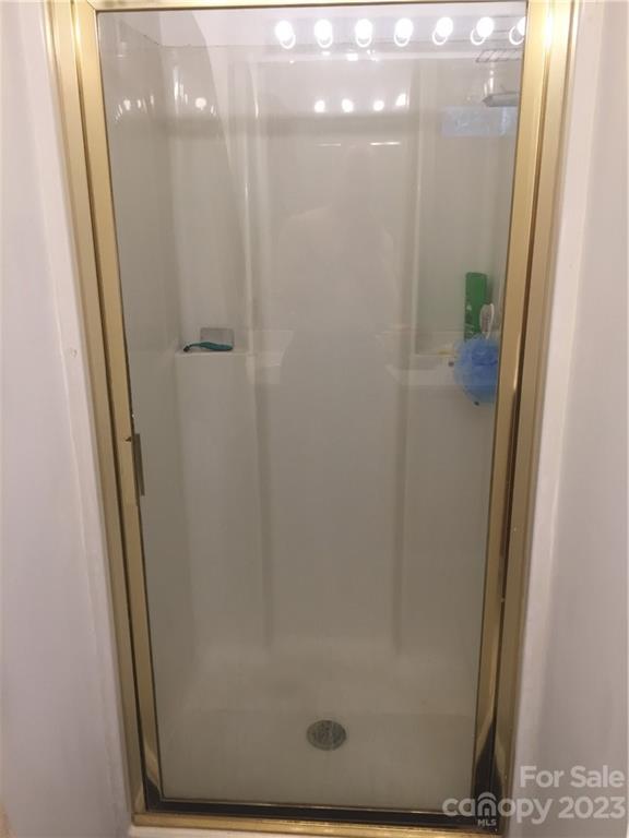 6019 Double Rein Road Charlotte, NC 28215 - Photo 17 of 21 a bathroom with a glass shower door