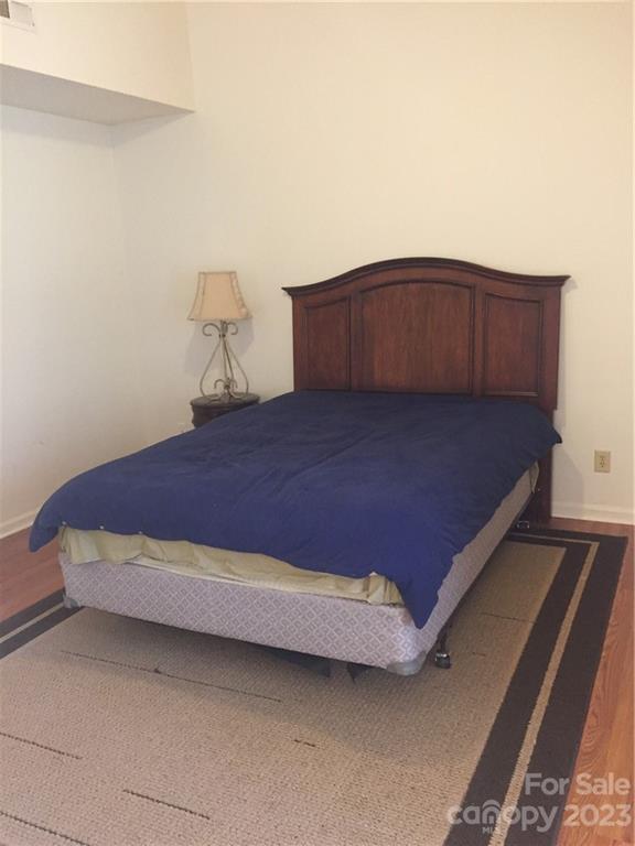 6019 Double Rein Road Charlotte, NC 28215 - Photo 18 of 21 a bedroom with a bed and dresser