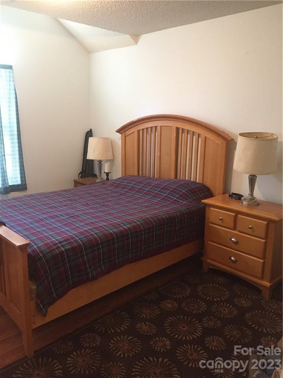 6019 Double Rein Road Charlotte, NC 28215 - Photo 21 of 21 a bedroom with a bed and wooden floor