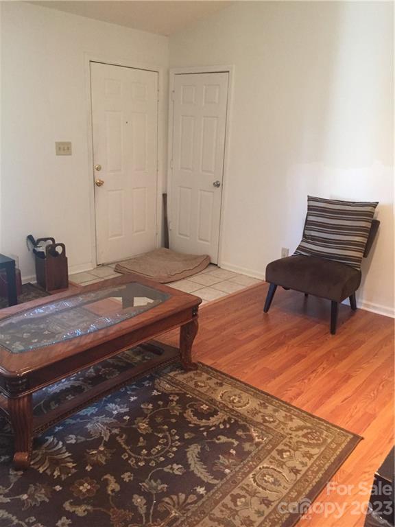 6019 Double Rein Road Charlotte, NC 28215 - Photo 3 of 21 a bedroom with a bed and wooden floor