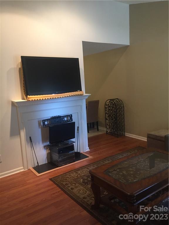 6019 Double Rein Road Charlotte, NC 28215 - Photo 4 of 21 a living room with a fireplace and a flat screen tv