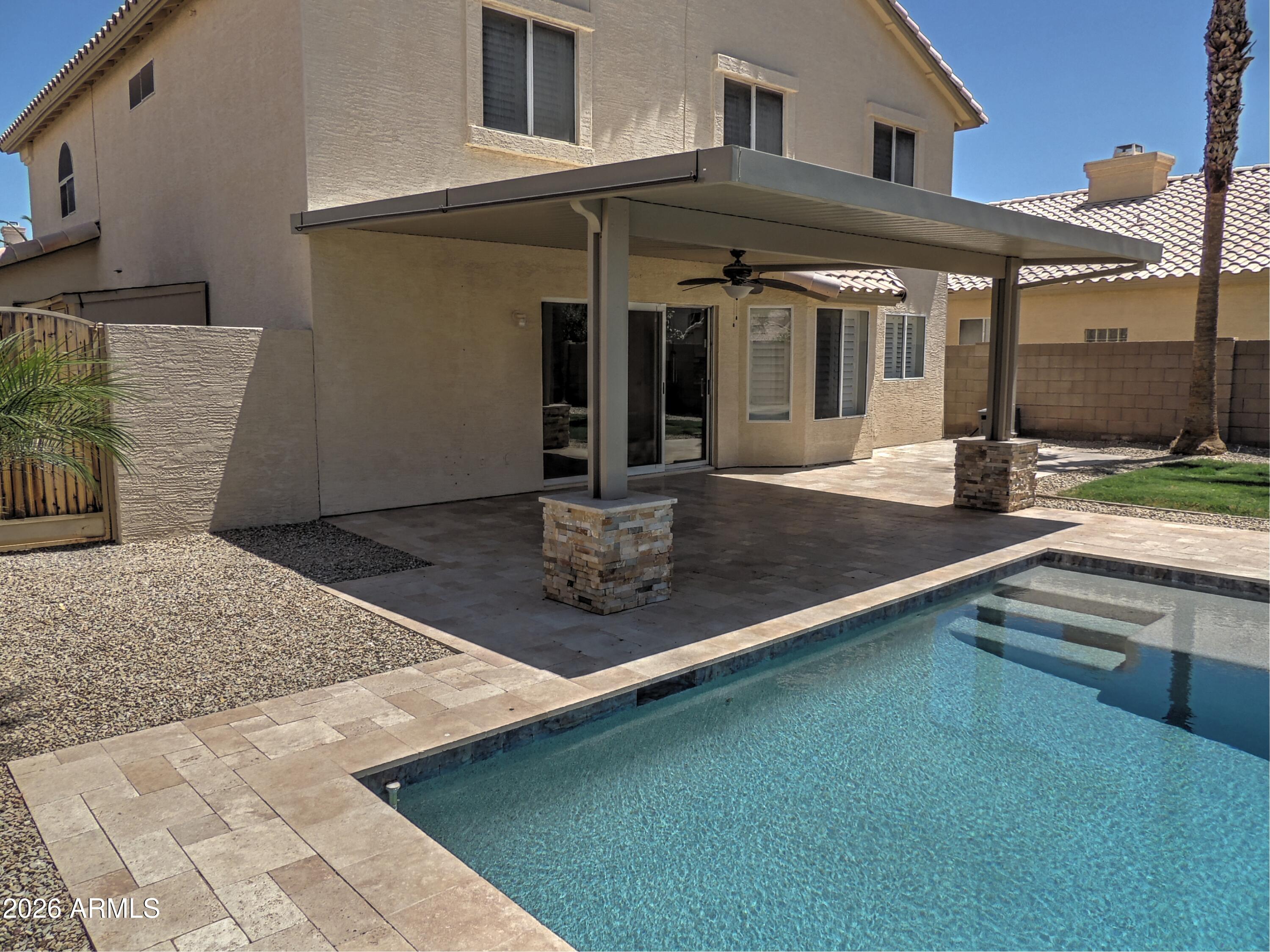 4409 East Dry Creek Road Phoenix, AZ 85044 - Photo 29 of 34 a view of a house with floor to ceiling windows and a kitchen