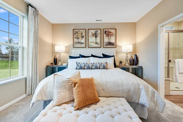 a bedroom with a large bed and a window