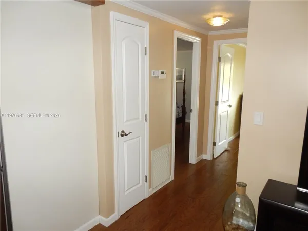 a view of a hallway with wooden floor