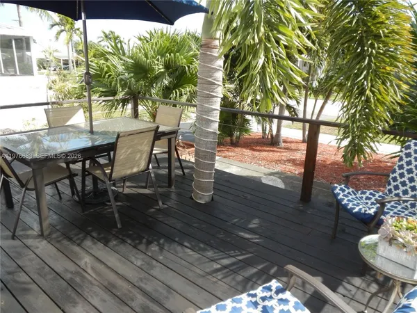 a view of a patio with table and chairs and potted plants