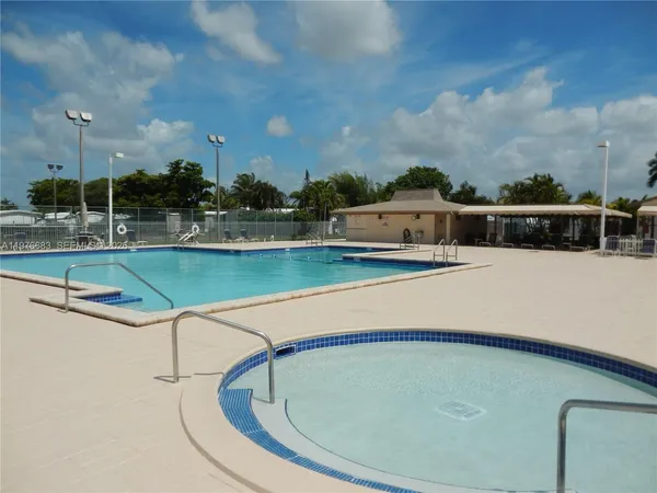 a view of a swimming pool with outdoor seating