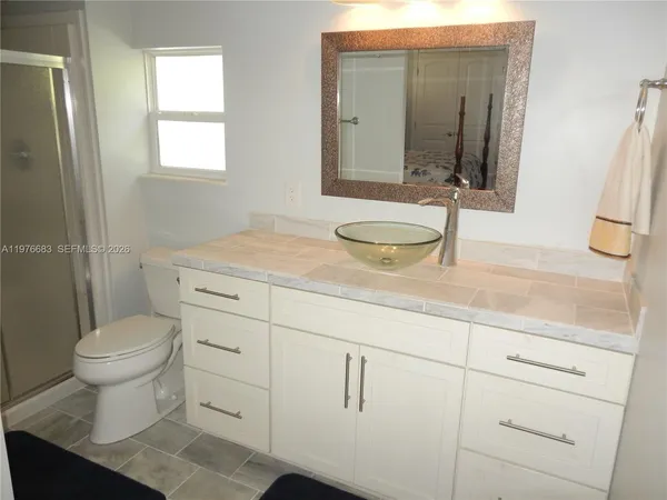 a bathroom with a sink toilet and mirror