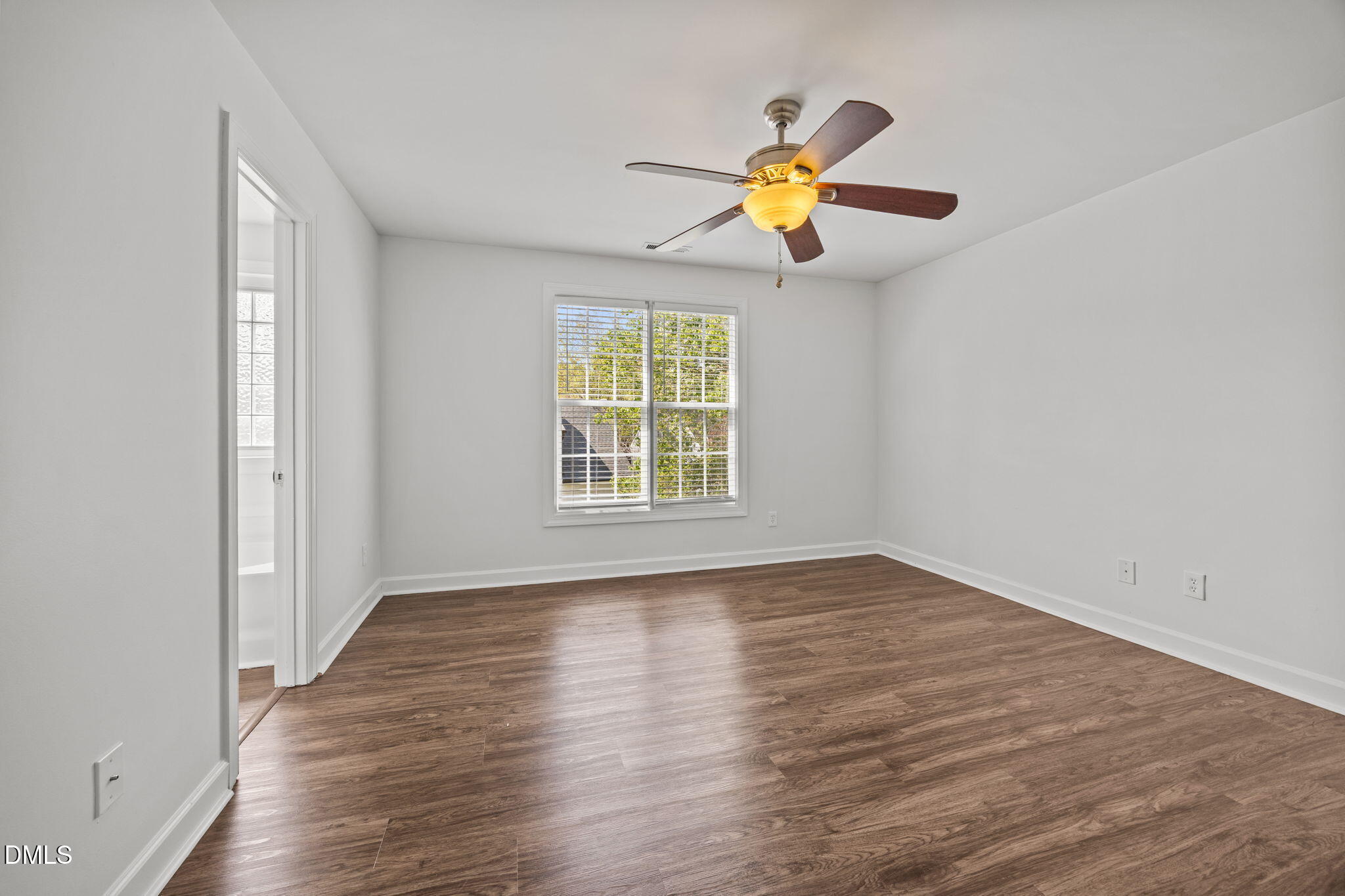 9220 Pennythorne Court Raleigh, NC 27615 - Photo 27 of 49 a view of an empty room with wooden floor and a window