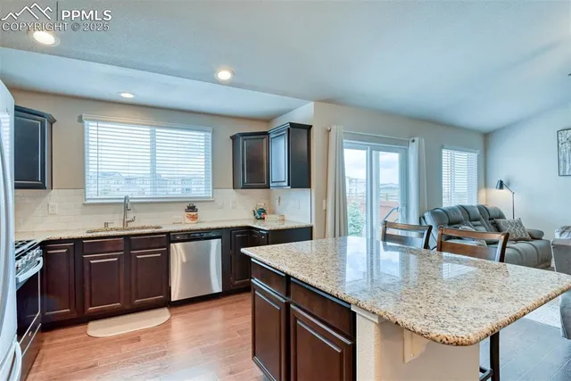 a kitchen with a sink window and cabinets