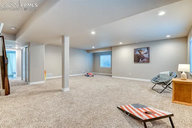 a living room with a couch and a table with potted plant