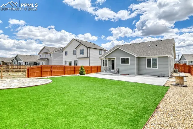 a front view of a house with a garden and yard