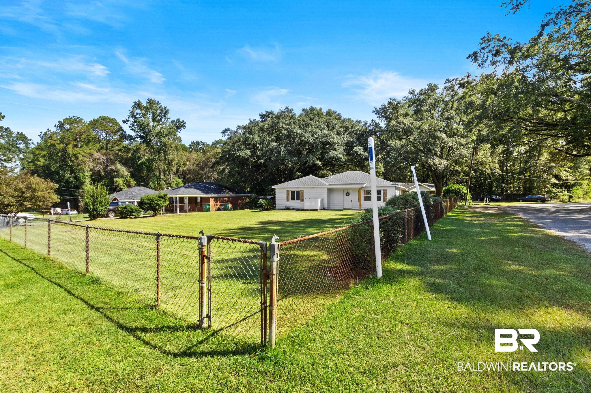 618 Pine Street Saraland, AL 36571 - Photo 22 of 41 View of yard with a gate