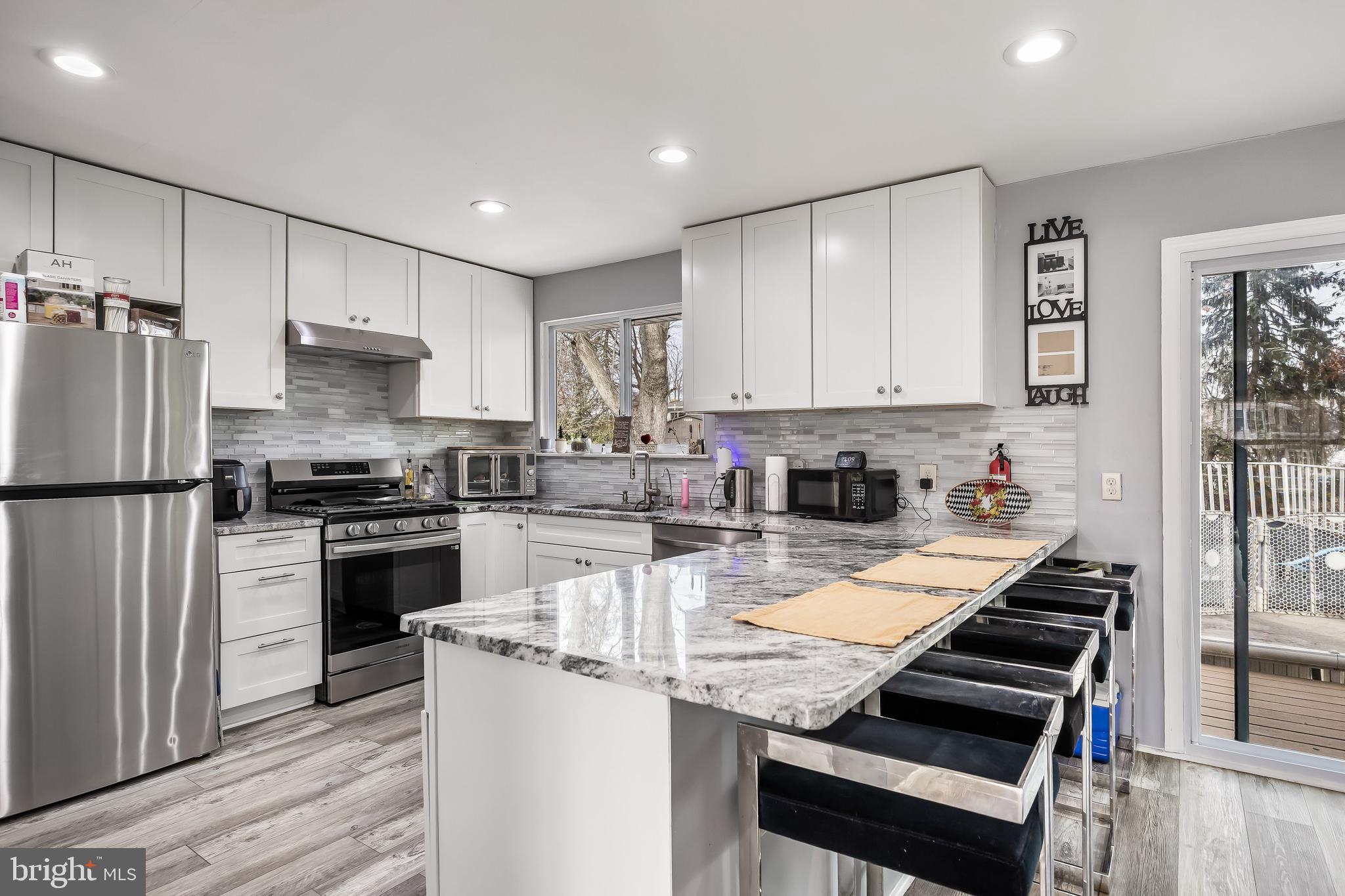 51 Suburban Boulevard Delran, NJ 08075 - Photo 11 of 29 a kitchen with kitchen island granite countertop a stove and a refrigerator