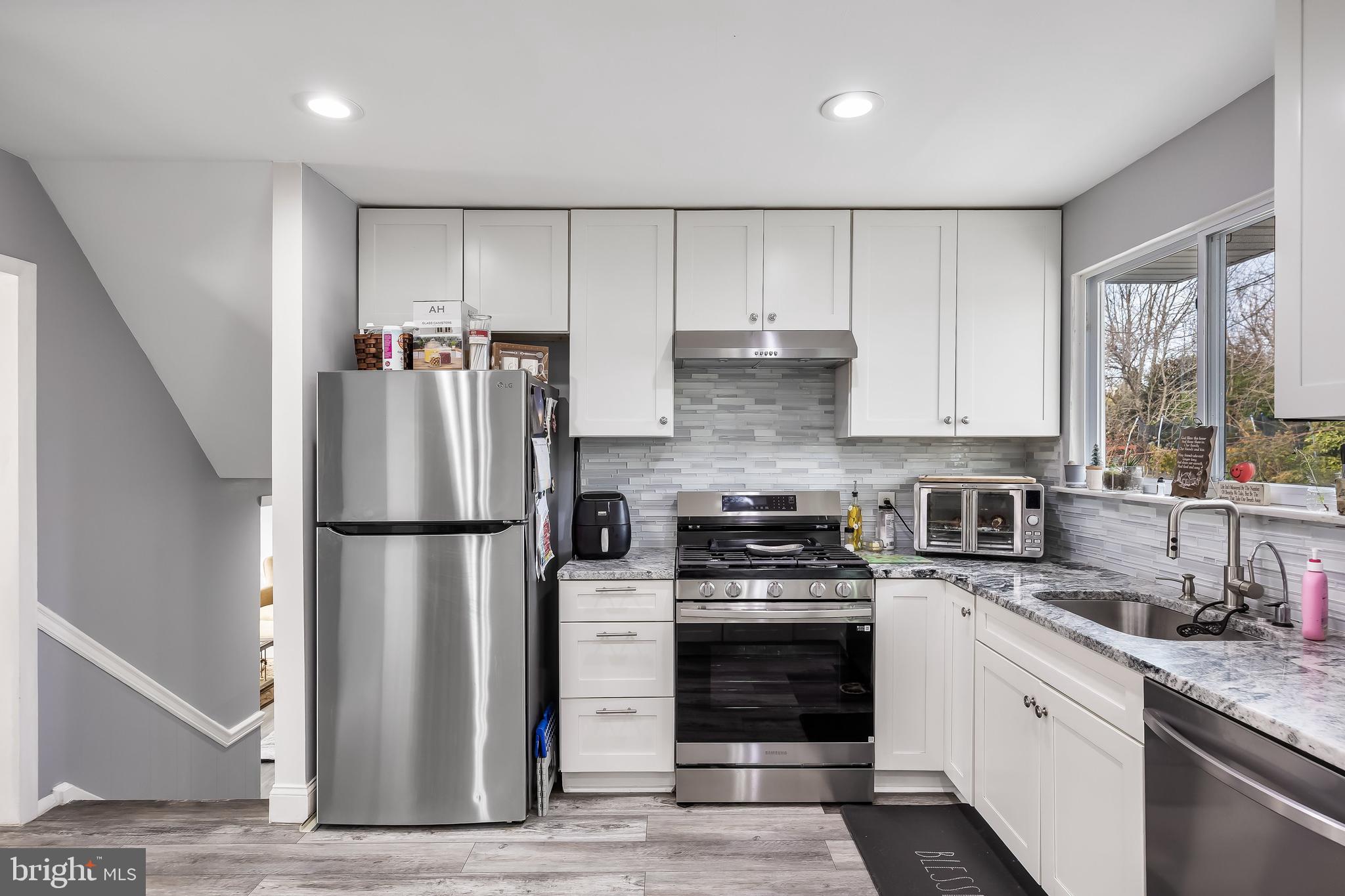 51 Suburban Boulevard Delran, NJ 08075 - Photo 13 of 29 a kitchen with a refrigerator a stove a sink and a window