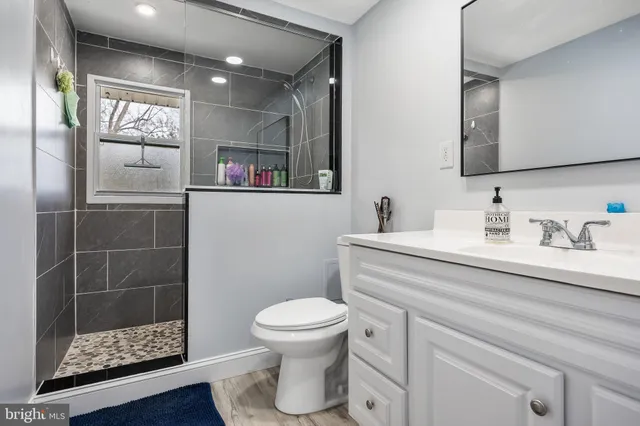 a bathroom with a toilet sink and shower