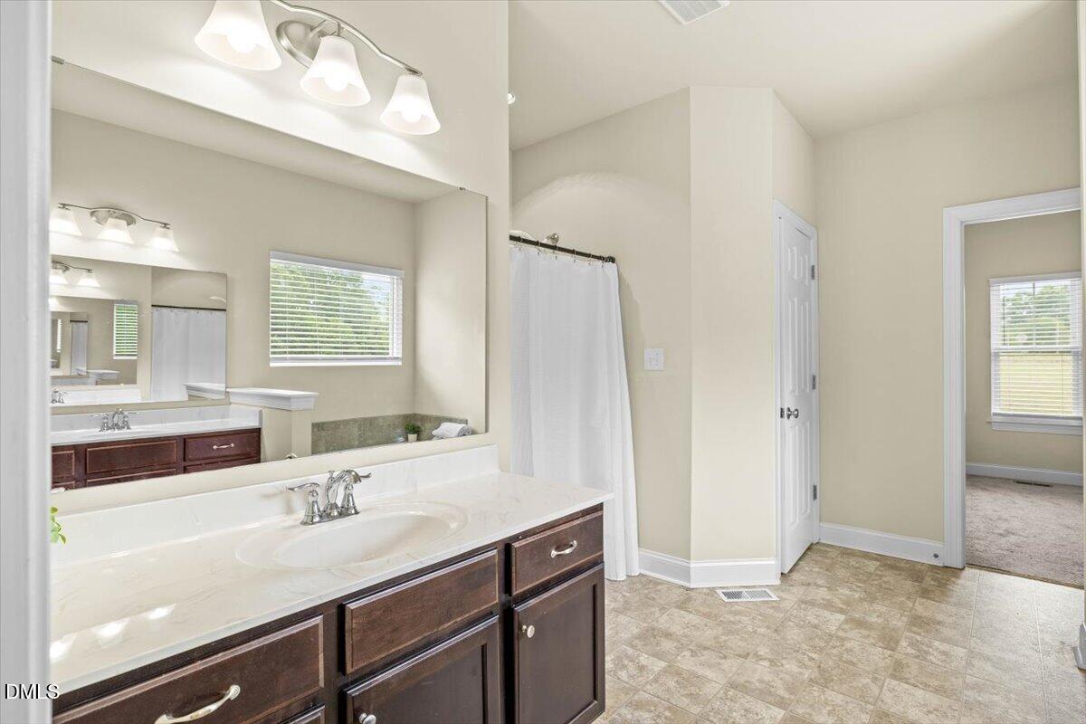704 Haw River Hopedale Road Burlington, NC 27217 - Photo 24 of 49 a bathroom with a sink a vanity and a mirror