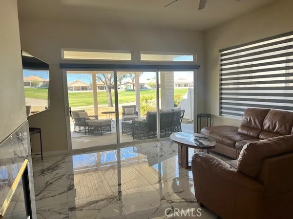 a living room with furniture and a floor to ceiling window
