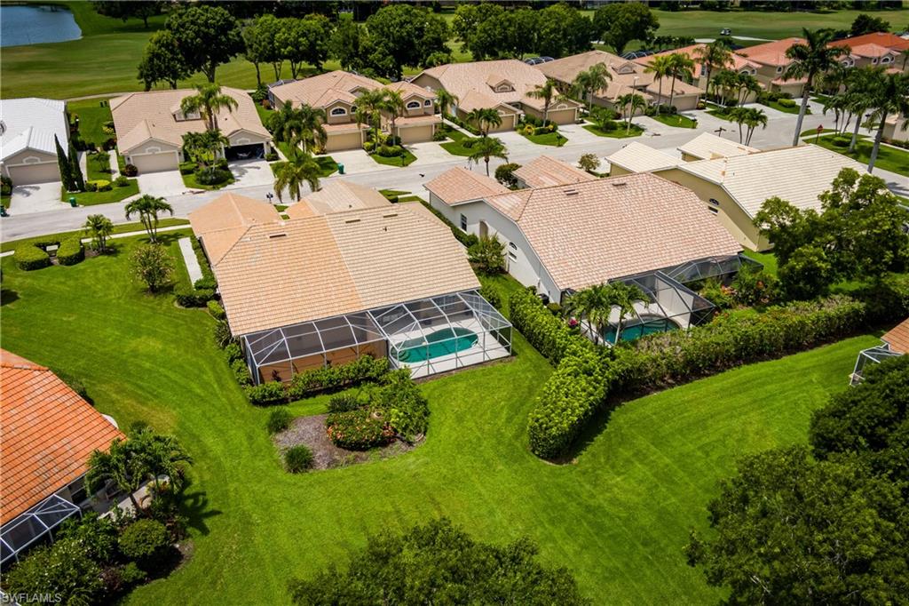 6658 Castlelawn Place, Unit 9 Naples, FL 34113 - Photo 34 of 38 Aerial view of a residential property featuring a screened-in swimming pool
