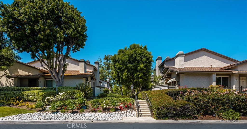 8 Moon Shadow, Unit 8 Irvine, CA 92603 - Photo 1 of 42 a front view of a house with a garden