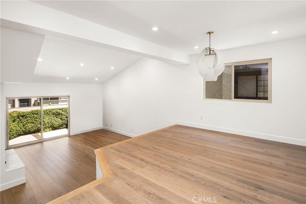 8 Moon Shadow, Unit 8 Irvine, CA 92603 - Photo 11 of 42 a view of an empty room with a window and wooden floor
